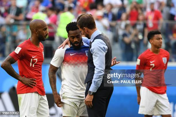 England's coach Gareth Southgate talks to England's defender Danny Rose as England's midfielder Fabian Delph looks on following the team's loss in...