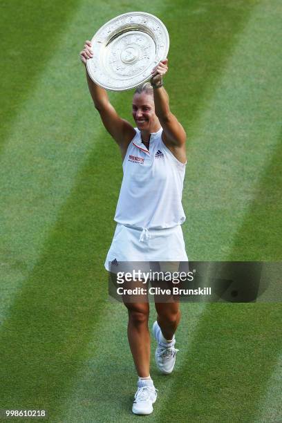 Angelique Kerber of Germany lifts the Venus Rosewater Dish after defeating Serena Williams of The United States in the Ladies' Singles final on day...
