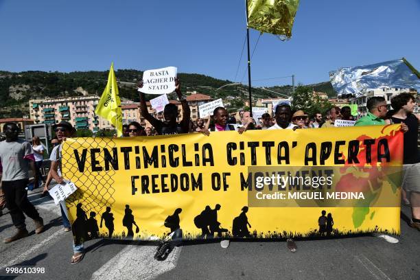 Peolpe hold a banner reading " Ventimiglia, open city, freedom of movement" during a demonstration at the call of an Italian association "Progetto...