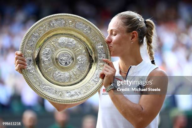 Angelique Kerber of Germany kisses the Venus Rosewater Dish as she poses for photographs after defeating Serena Williams of The United States in the...