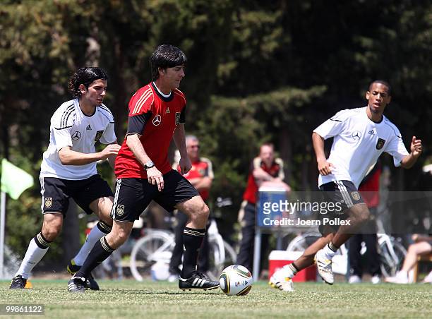 Head coach Joachim Loew of Germany plays the ball during the German National Team training session at Verdura Golf and Spa Resort on May 18, 2010 in...