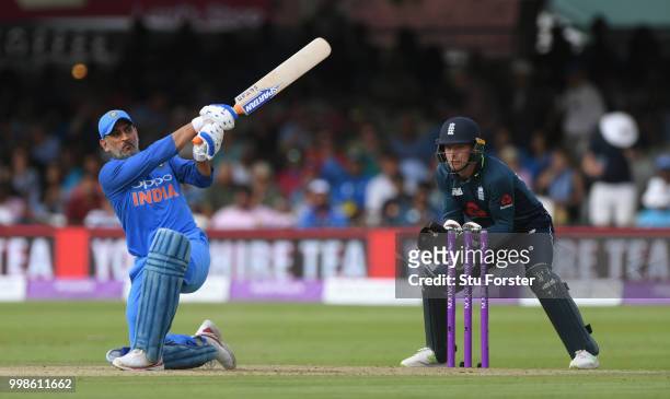 India batsman MS Dhoni hits out watched by Jos Buttler during the 2nd ODI Royal London One Day International match between England and India at...