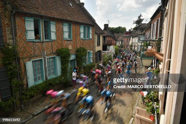 The pack rides through the village of Gerberoy during the eighth stage of the 105th edition of the Tour de France cycling race between Dreux and...