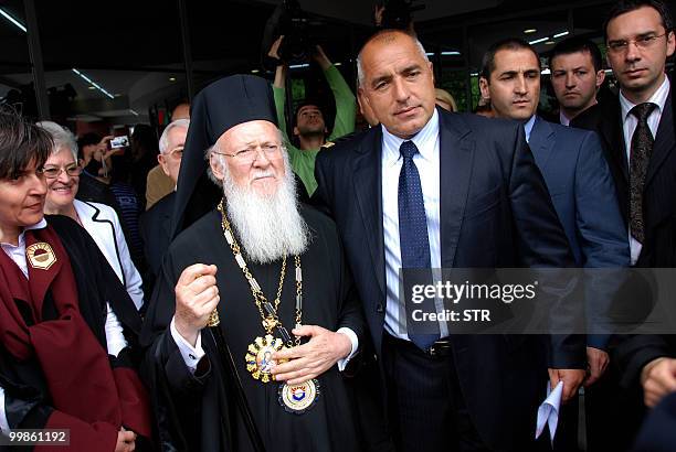 Ecumenical Patriarch Bartholomew walks with Bulgarian Prime Minister Boyko Borisov after receiving the "Doctor Honoris Causa" award from the Free...