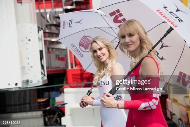 The grid girls walk in paddock during the qualifying practice during the MotoGp of Germany - Qualifying at Sachsenring Circuit on July 14, 2018 in...
