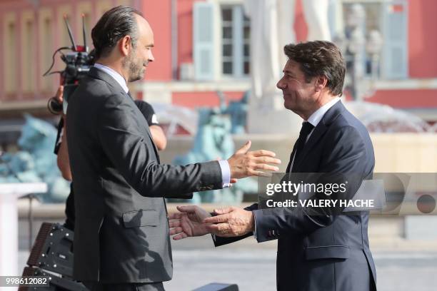 Nice's mayor Christian Estrosi welcomes French Prime minister Edouard Philippe in Nice on July 14, 2018 for a ceremony marking the second anniversary...