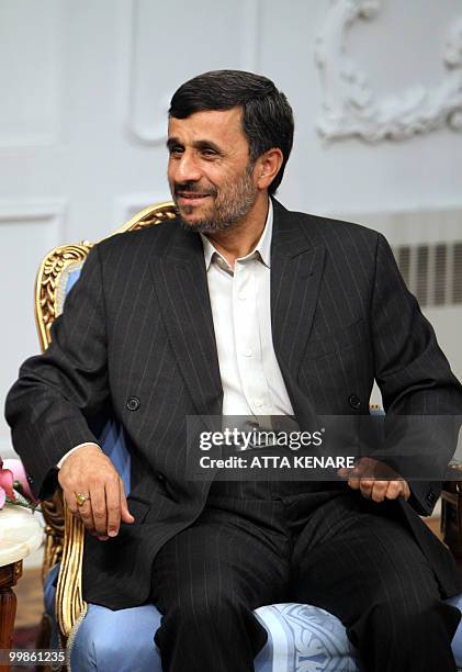 Iranian President Mahmoud Ahmadinejad adjusts his jacket during a meeting at the presidency in Tehran, on May 18, 2010. Iranian officials said that...