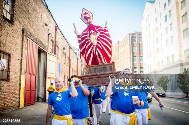 Statue of San Fermin, patron saint of the traditional Running of the Bulls festival in Pamplona, is carried to begin the New Orleans Running of the...