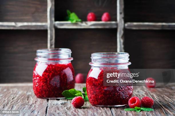 homemade jam with raspberry on the wooden table - raspberry jam stock pictures, royalty-free photos & images