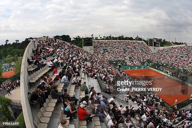 People sit in the Suzanne Lenglen stadium during the French tennis Open fourth round match between Swiss Swiss player Patty Schnyder and Slovenian...