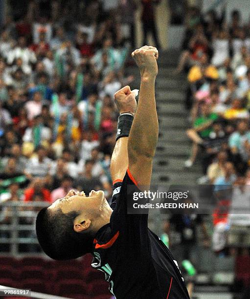 Japan's Sho Sasaki celebrates his victory over Indonesia's Simon Santoso during their singles semi-final in the Thomas Cup badminton championships in...