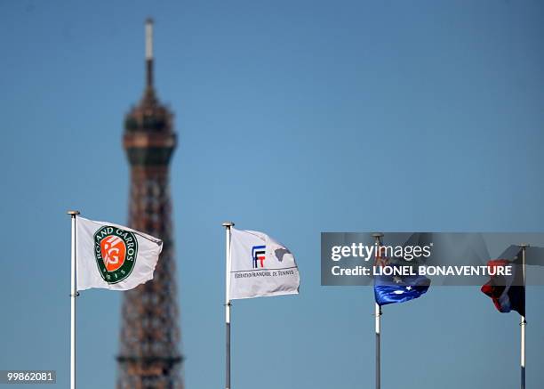 Flags are pictured backdropped by the Eiffel Tower during the French Open tennis tournament on May 29, 2009 at Roland Garros stadium in Paris. The...