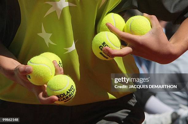 Ball boy carries ball during play between German player Tommy Haas and French player Jeremy Chardy during their French Open tennis third round match...
