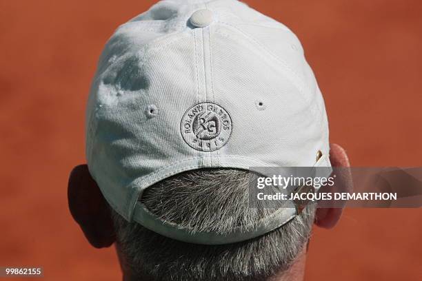 Man sports a Roland Garros cap during play between German player Tommy Haas and French player Jeremy Chardy during their French Open tennis third...