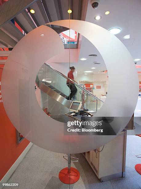 Vodafone employee works at a company store in London, U.K., on Tuesday, May 18, 2010. Vodafone Group Plc said it will increase future dividend...