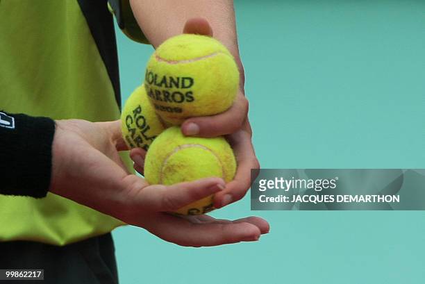 Ball boy hols tennis balls during play against US Serena Williams and Russia's Svetlana Kuznetsova during a French Open tennis quarter final match on...