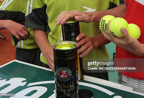 Ball persons handles balls during play between Argentinian player Juan Martin Del Potro and Spanish player Tommy Robredo during a French Open tennis...