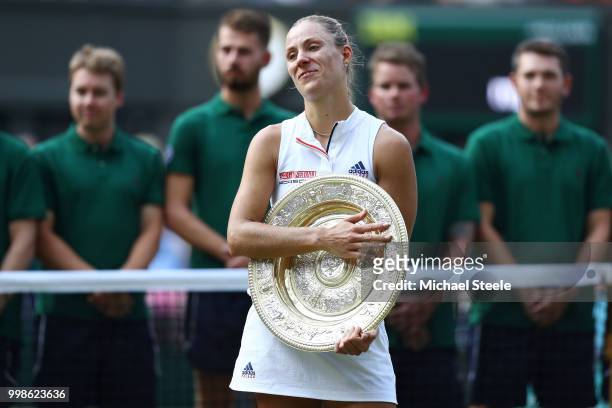 Angelique Kerber of Germany reacts as she holds the Venus Rosewater Dish after defeating Serena Williams of The United States in the Ladies' Singles...