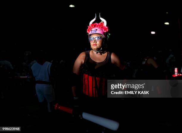 Roller derby girls, dressed as bulls, chase people with bats to swat them on their behinds during the annual Running of the Bulls in the Central...
