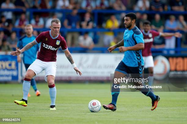 Ellis Deeney of AFC Telford United competes with Glenn Whelan of Aston Villa during the Pre-season friendly between AFC Telford United and Aston...