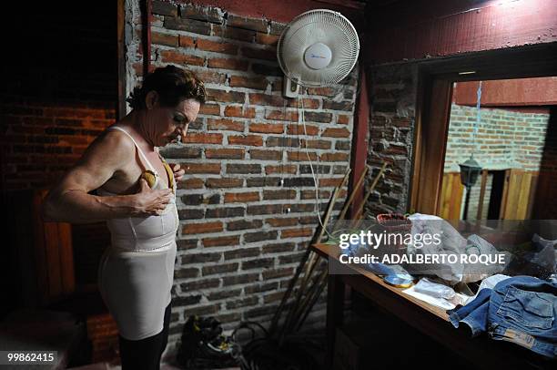 Cuban transvestite Roxi Rojo gets ready for a transvestite show, on May 17, 2010 in Santa Clara city -300 km from Havana. This transvestite show, the...