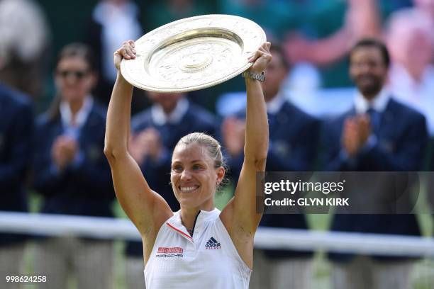 Germany's Angelique Kerber poses with the winner's trophy, the Venus Rosewater Dish, after her women's singles final victory over US player Serena...