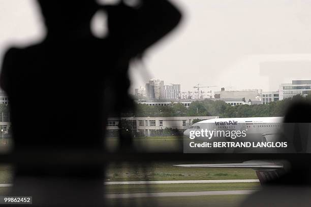 Journalist films an Iran Air plane which alledgedly is to carry home Iranian agent Ali Vakili Rad, on May 18, 2010 at Paris-Orly airport after his...