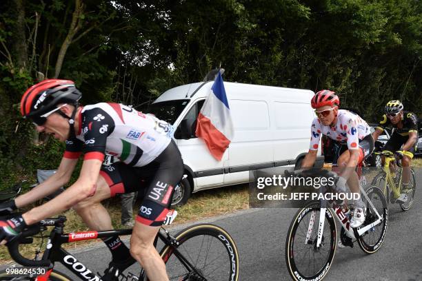 Ireland's Daniel Martin and Latvia's Toms Skujins get going again after being caught in a crash during the eighth stage of the 105th edition of the...