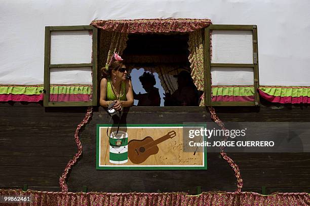 Pilgrim looks out from a window as she makes her way to the shrine in El Rocio in Donana national park during the annual El Rocio pilgrimage, on May...