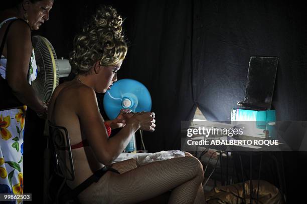 Cuban transvestite Lazaro Diaz gets ready for a transvestite show, on May 17, 2010 in Santa Clara city -300 km from Havana. This transvestite show,...