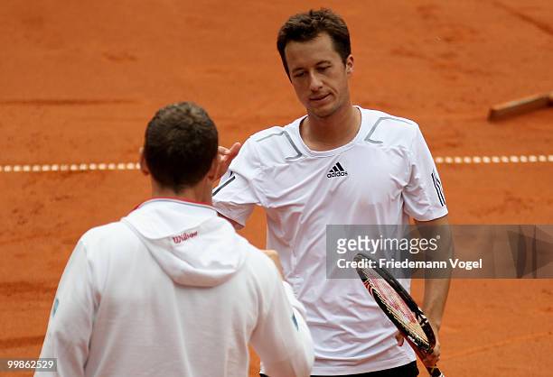 Philipp Kohlschreiber of Germany celebrates with National coach Patrick Kuehnen after winning his match against Horacio Zeballos of Argentina during...