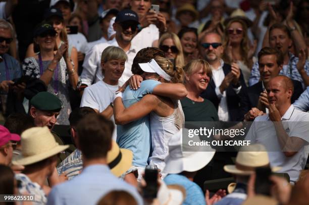 Germany's Angelique Kerber heads to the player's family box as she celebrates winning against US player Serena Williams during their women's singles...