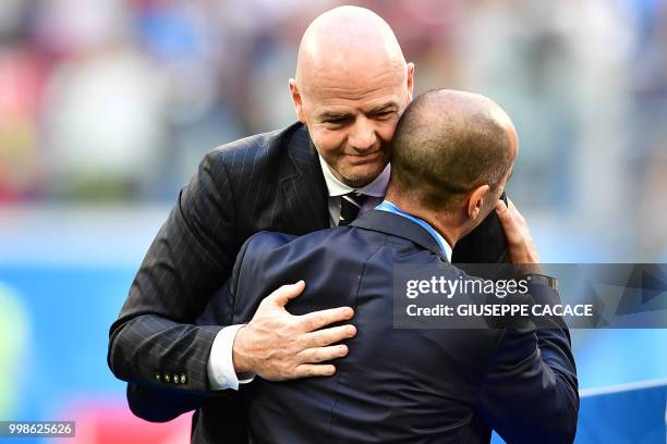 Belgium's coach Roberto Martinez is congratulated by Swiss-Italian FIFA president Gianni Infantino at the end of their Russia 2018 World Cup play-off...