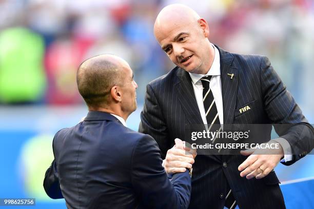 Belgium's coach Roberto Martinez is congratulated by Swiss-Italian FIFA president Gianni Infantino at the end of their Russia 2018 World Cup play-off...