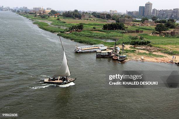 General view shows Egyptian sailboats, known as falukas, and a small ferryboat used by locals to cross from one side of the River Nile to the other...