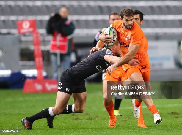 Jaguares' fullback Ramiro Moyano is tackled by Sharks' fullback Curwin Bosch during the Super Rugby match between the Sharks and the Jaguares at the...