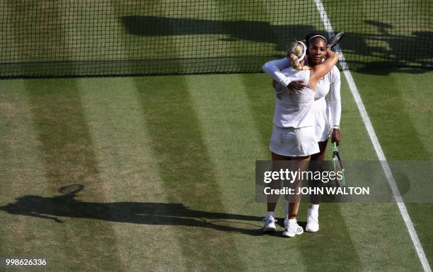 Germany's Angelique Kerber embraces US player Serena Williams following their women's singles final match on the twelfth day of the 2018 Wimbledon...