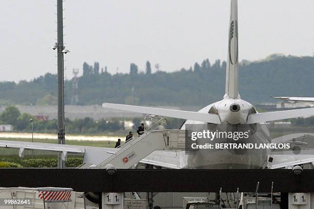 Iranian agent Ali Vakili Rad escorted by policemen climbs aboard an Iranian Air plane which will carry him back home to Iran at the Orly airport,...