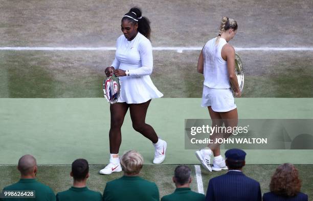 Germany's Angelique Kerber carries the winner's trophy, the Venus Rosewater Dish, after her women's singles final victory over US player Serena...