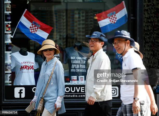 Tourists from Japan passes by a souvenir shop decorated with Croatia's national flags on July 14, 2018 in Zagreb, Croatia. This is the first time...