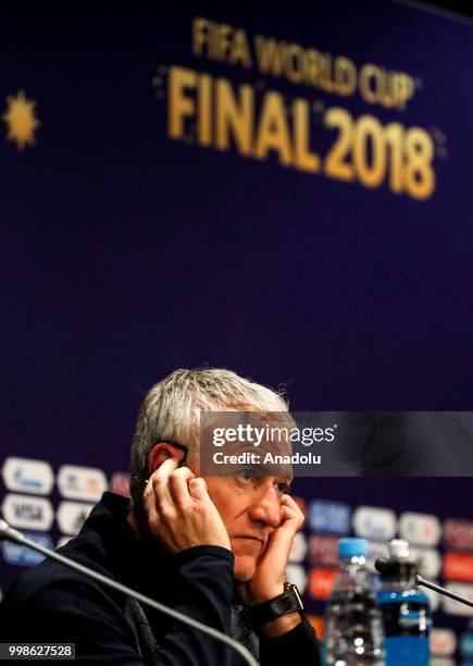 Head coach Didier Deschamps of France adjusts headphones during team France press conference ahead of the final match of the 2018 FIFA World Cup...