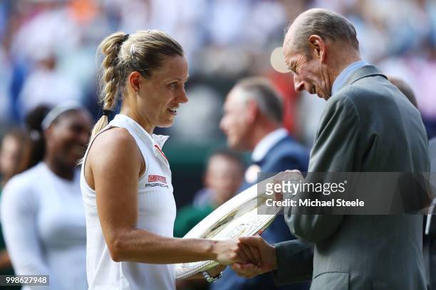 Prince Edward, Duke of Kent presents Angelique Kerber of Germany with the Venus Rosewater Dish after the Ladies' Singles final between Angelique...