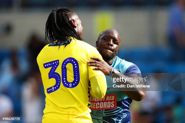 Adebayo Akinfenwa of Wycombe Wanderers embraces team-mate Yves Ma-Kalambay after the pre-season friendly match between Wycombe Wanderers and West Ham...