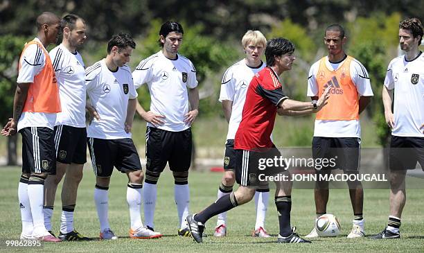 Germany's head coach Joachim Loew explains tactics to Germany's defender Jerome Boateng, Germany's defender Heiko Westermann, Germany's midfielder...