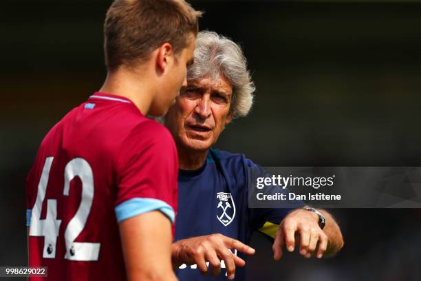 West Ham manager Manuel Pellegrini speas with Martin Samuelsen during the pre-season friendly match between Wycombe Wanderers and West Ham United at...