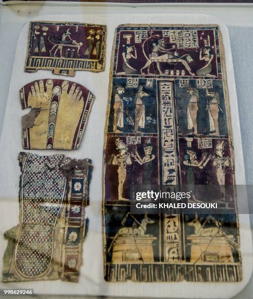 Picture taken on July 14, 2018 shows Pharaonic artifacts on display in front of the step pyramid of Saqqara, south of the Egyptian capital Cairo. -...