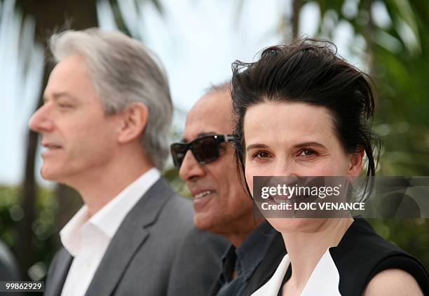 French actress Juliette Binoche , Iranian director Abbas Kiarostami and British actor William Shimell pose during the photocall of "Copie Conforme"...