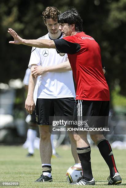 Germany's head coach Joachim Loew explains tactics to Germany's defender Arne Friedrich during a training session at the Verdura Golf and Spa resort,...