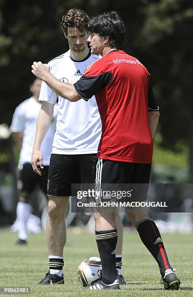 Germany's head coach Joachim Loew explains tactics to Germany's defender Arne Friedrich during a training session at the Verdura Golf and Spa resort,...