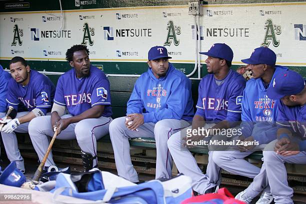 Andres Blanco, Vladimir Guerrero, Nelson Cruz, Joaquin Arias and Max Ramirez of the Texas Rangers sitting in the dugout prior to the game against the...